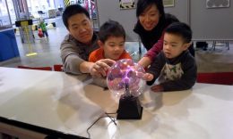 Family Touching Electricity Exhibit