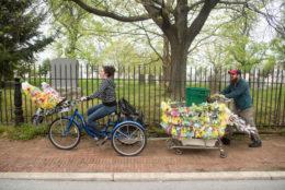 woman riding a bike decorated with trash bags